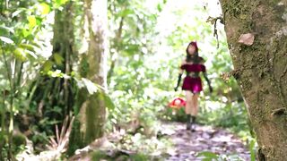 Little Red Riding Hood walking alone in the forest