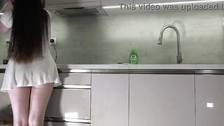 Fresh wife sexy brunette hair honey with large breasts large booty in the kitchen with a short white transparent costume shows what that babe has
