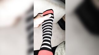 Relaxing foot massage - nude feet and nylon socks (close-up)