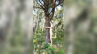 Shinrin-yoku: Naturist Tree Hugging In nature's garb in Forest (grounding) - rubbing against a tree