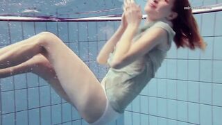 Small cute Nastya swims underwater stripped