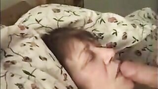 Granny lying on the bed get jizz in throat