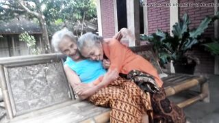 two Very old grannies giving a kiss