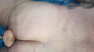 Taking my dildos laying on my belly still in a flat chastity cage