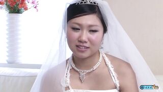The fresh Oriental bride remains attired in her bridal gown through a visitor's arrival